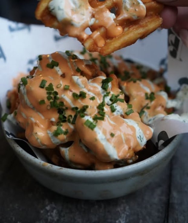 Loaded waffle fries in a bowl